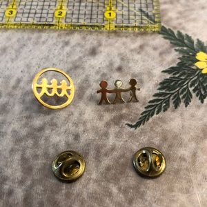 Two pins of three stick people